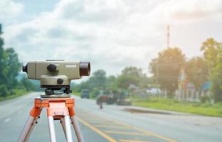 Surveyor equipment tacheometer or theodolite with road construction site background photo