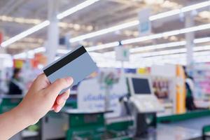 paying using credit card at supermarket checkout cashier photo