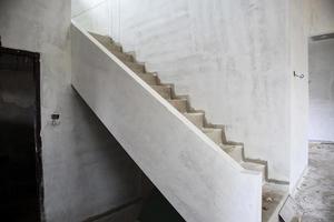 New house construction with concrete staircase at building site photo