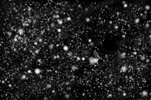 Abstract snowfall on black background photo