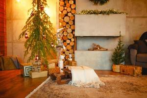 Christmas interior in the style of a Scandinavian loft gray concrete, wooden decor, incandescent lamps, realistic artificial Christmas tree. Cozy new year in a country house photo