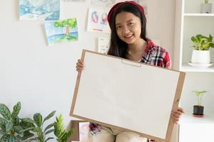 Young girl hold frame and paper at home. Hobby and art study at home. photo