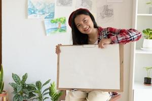 Young girl hold frame and paper at home. Hobby and art study at home. photo