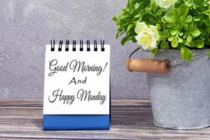 Motivational quote on stand note with potted plant on wooden desk photo