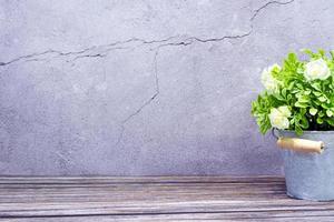 Potted plant on wooden table tap at brick wall. Home green plant. photo