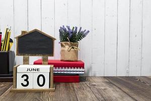 30 de junio texto de fecha de calendario en un bloque de madera blanco una mesa. foto