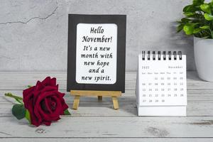 Motivational quotes on paper frame with November 2022 calendar. photo