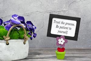 Inspirational quote on a paper frame - Trust the process. Be patient to yourself photo