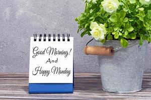 Motivational quote on stand note with potted plant on wooden desk photo