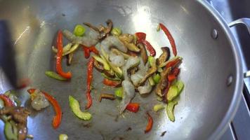 Peppers and onions saute in a wok video