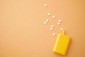 artificial sweetener container on orange background photo