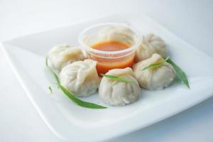 close up of chicken momo dumpling on a plate photo