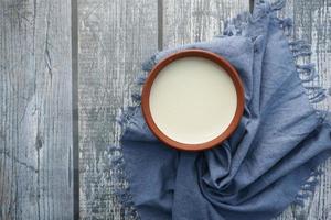 fresh yogurt in a bowl on table photo