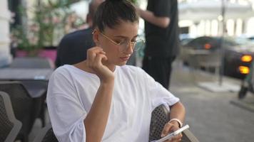 Beautiful woman at cafe outdoor table video