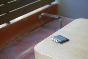 left wallet on a bench in the park photo