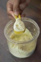 Close up of baby milk powder and spoon on tile background. photo