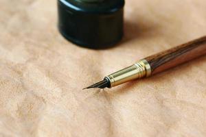 old empty paper and fountain pen on table photo