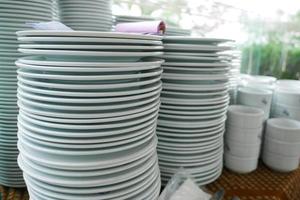 stack of many white color plate on table photo