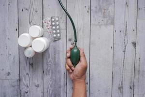 top view of men hand using blood pressure machine on table photo