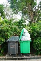 Bag with garbage and rubbish bin photo