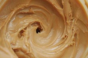 top view of peanut butter in a container , photo