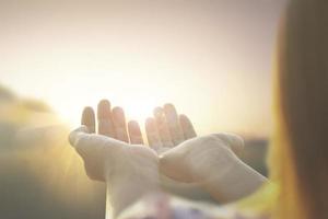 women hand raised and sunrise summer nature background .freedom concept photo