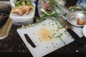 Dirty Chopping board with Knife after cooking in the kitchen. photo