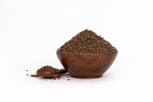 Indigofera or indigo seeds in wooden bowl photo