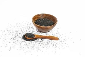 nigella o comino negro con semillas medicinales de tulsi sobre fondo blanco foto
