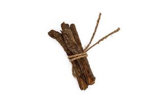 Set with dried sticks of mulethi or Glycyrrhiza glabra root on white background photo