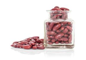 Bottle full of Kidney  beans white background photo