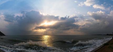 Sunset with dramatic cloud over sea photo