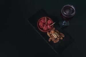 tapa de chorizo en salsa típica española con pan y vino tinto de verano foto