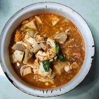 Taste the delicacy of Seblak, namely savory and spicy dishes from Indonesia. Seblak contains vegetables, squid, meatballs, sausage, crackers, eggs, and spices. Seblak is also easy to cook at home. photo