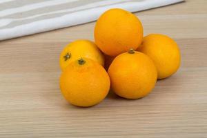 Tangerine on wooden background photo