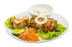 Chicken Tikka on the plate and white background photo