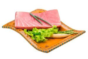 Tuna raw steak on the plate and white background photo