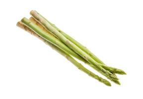 Raw asparagus on white background photo