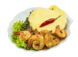 Garlic shrimps with potato on the plate and white background photo