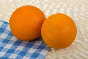 Orange on wooden background photo