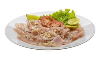 Swordfish carpaccio on the plate and white background photo