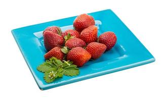 Ripe strawberry on the plate and white background photo