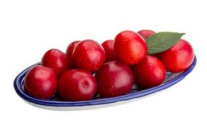 Damson plum in a bowl on white background photo