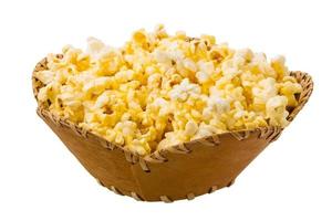 Popcorn in a basket on white background photo