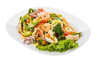 Asian seafood salad on the plate and white background photo