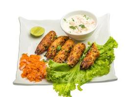 Shish kebab on the plate and white background photo