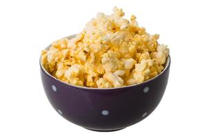 Popcorn in a bowl on white background photo