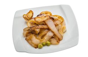 Fried onion on the plate and white background photo