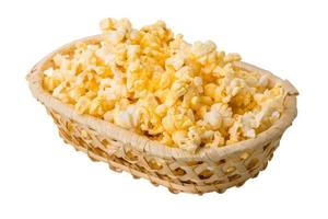 Popcorn in a basket on white background photo