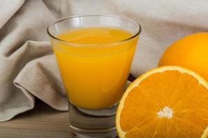 Orange juice on wooden background photo